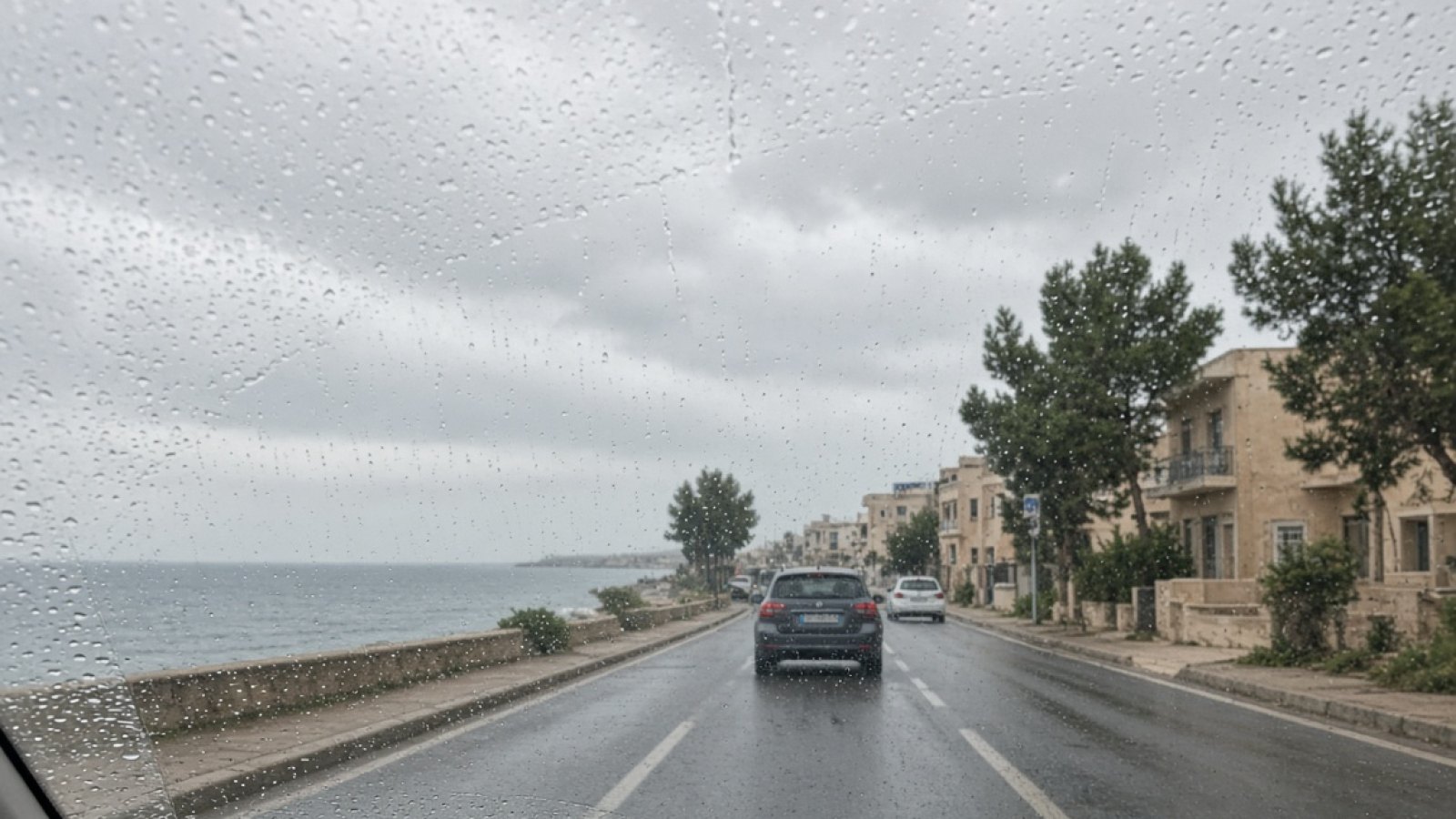 Kıbrıs'ta yağmurlu havada trafikte güvenli şekilde ilerleyen aile aracı